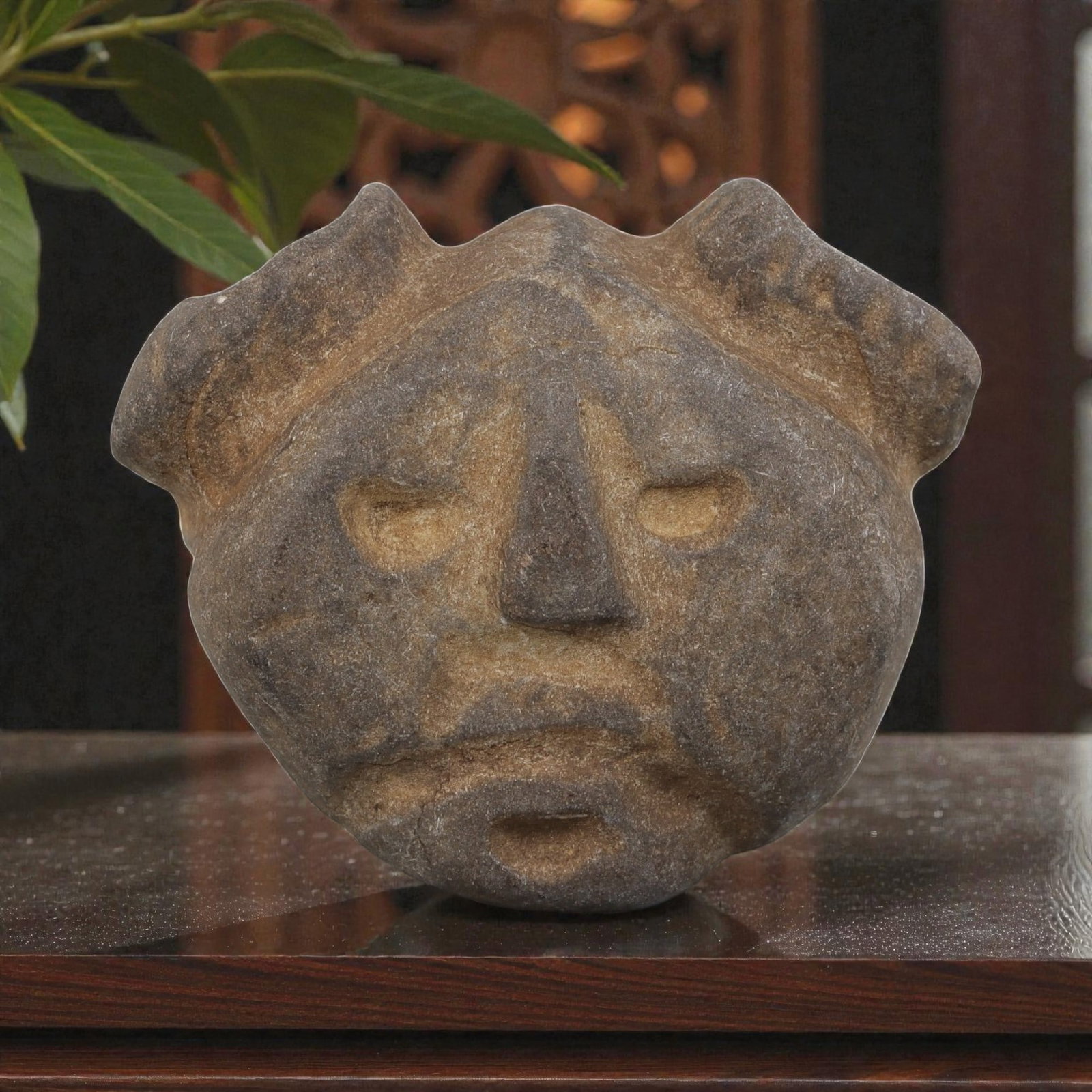 Antique Medieval Carved Stone Anthropomorphic Maskette, 83AN: Crafted from weathered grey stone with natural patination and surface wear, this maskette depicts a stylized anthropomorphic face. The design features recessed eyes, a prominent triangular nose, a sim