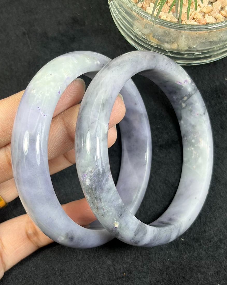 Lot of 2 Natural Burmese Type A Lavender Ink Jadeite Bangles, 35AV: Pair of untreated genuine Type A jadeite bangles with close sizing 58.3mm and 58.7mm inner diameter, soft lavender base naturally swirled with dark ink grey cloud veining and tiny purple mineral fleck