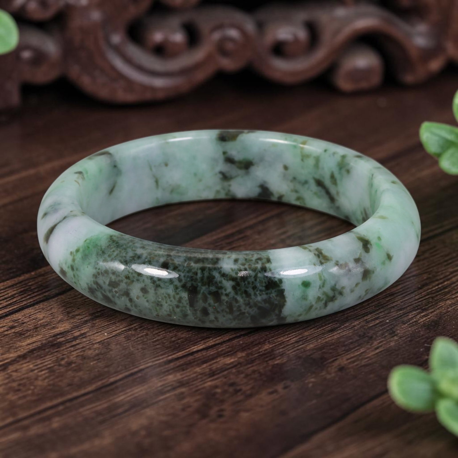 Natural Burmese Type A Dark Spotted Green Jadeite Jade Bangle Bracelet - Speckled Moss in Snow: Crafted from natural Burmese Type A jadeite jade, this wide bangle features dense dark green speckles clustered together against a pale milky white base, creating a rich spotted Moss in Snow pattern. 
