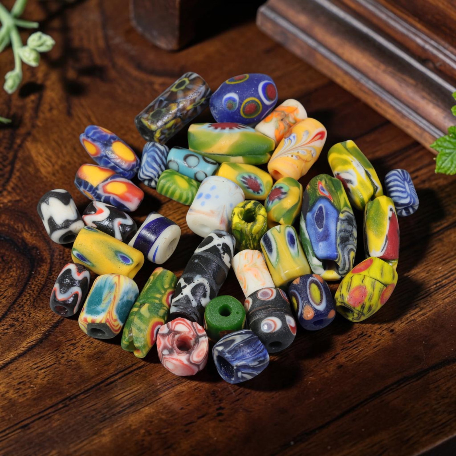 Vintage Venetian Millefiori Glass Beads - 34 Mixed Barrel Beads, 8AY: This lot contains 34 antique Venetian glass barrel beads, each measuring 1-2 cm long. These handcrafted millefiori beads showcase varied eye patterns, swirls, and colourful mosaic floral designs with 