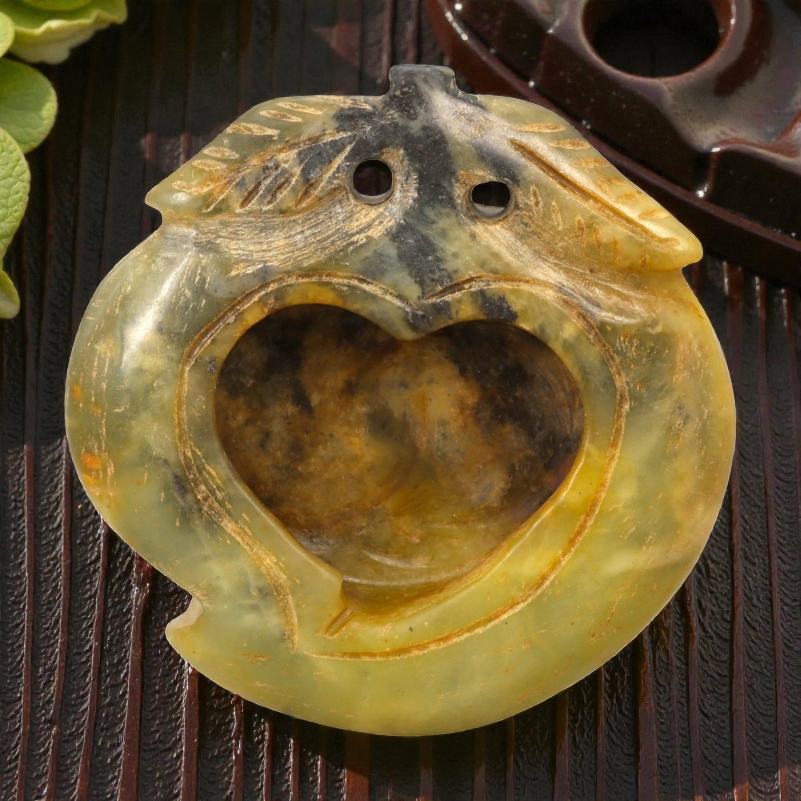 A Chinese Hardstone Miniature Decorative Vessel, 34YB: Carved from translucent greenish-yellow hardstone with areas of darker veining and natural inclusions, the vessel is worked in a compact, rounded form with a deeply hollowed interior. The exterior is 