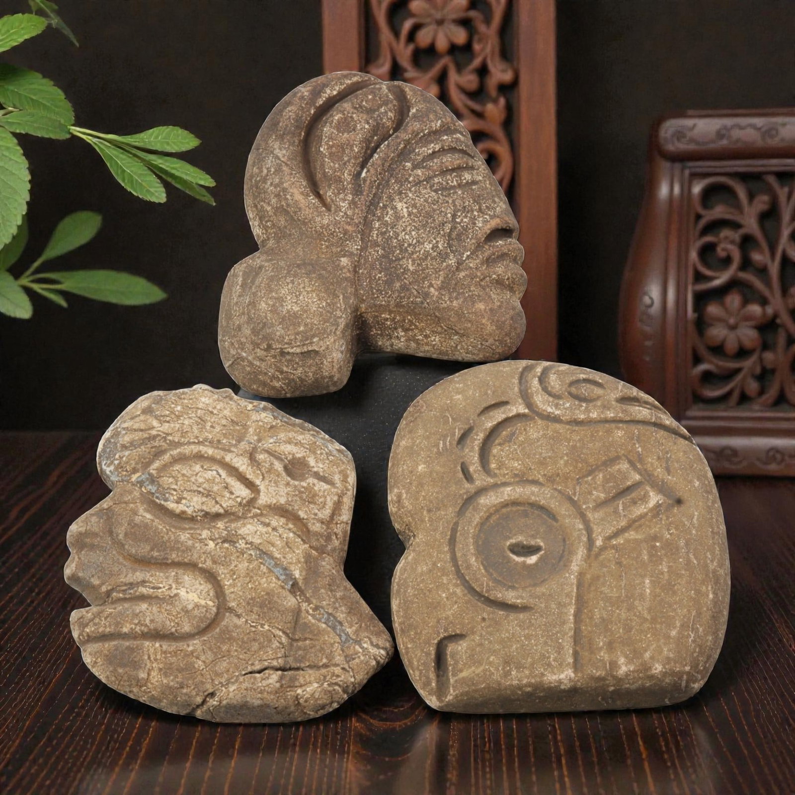 Lot of 3 Tribal Stone Carvings - Anthropomorphic Heads, 26WT: Three carved stone heads of tribal or pre-Columbian stylistic origin, each worked from a single piece of brown stone with visible natural fissures and surface weathering. The first depicts a profile h