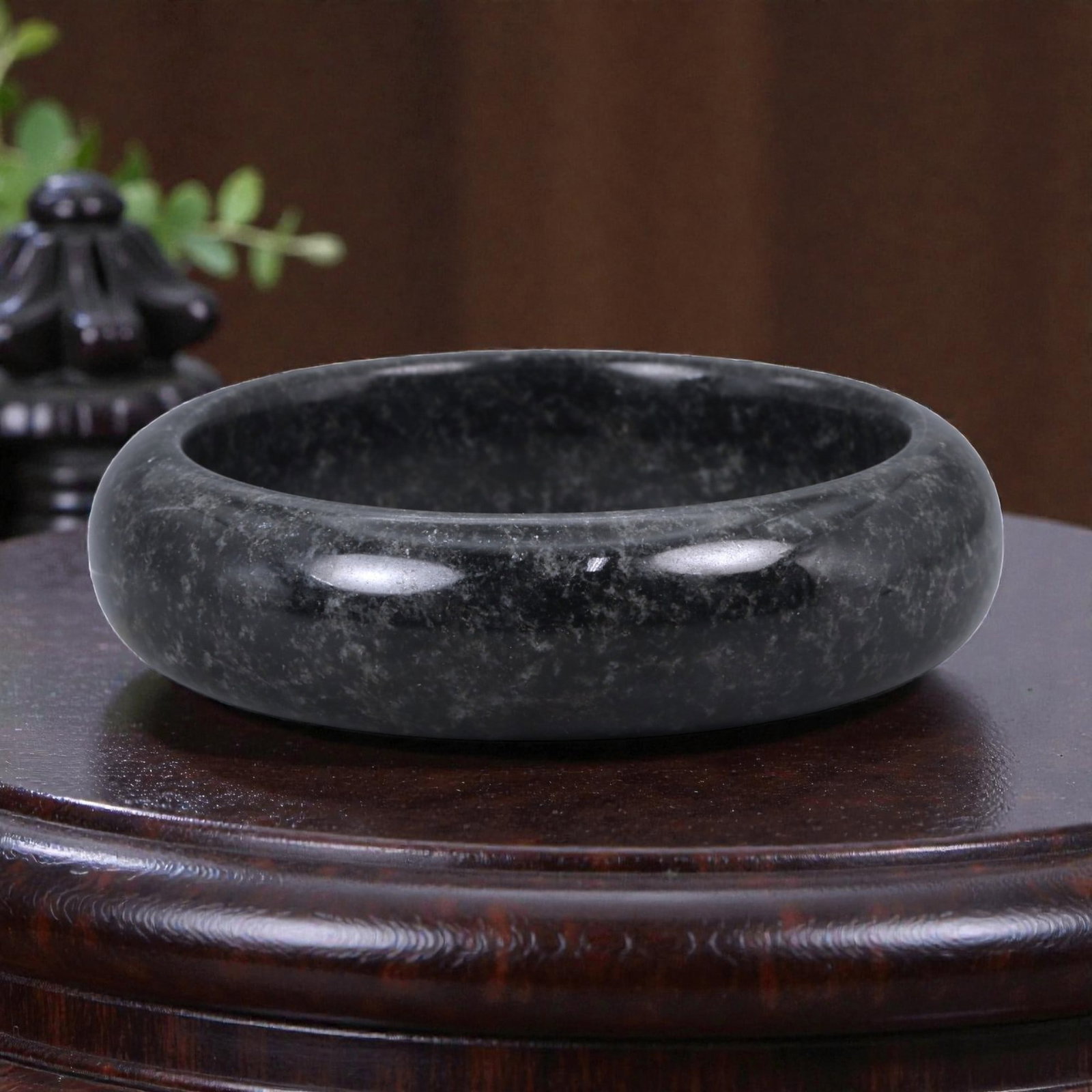 A Chinese Jadeite Bracelet Bangle, 6.4cm Inner Diameter, 13WE: Carved from jadeite, the bracelet is formed as a continuous circular bangle with a rounded cross-section and a uniformly polished surface. The interior and exterior edges are smoothly finished, indica