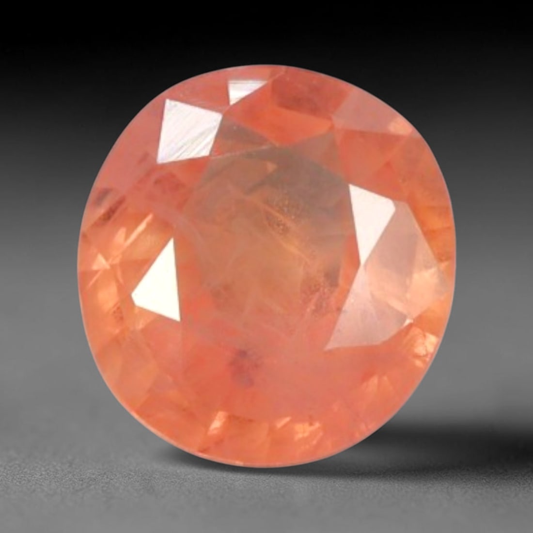 0.88 Carats Natural Peach Orange Sapphire Oval Faceted Gem, 79YE: I've got a real nice little gem here to show you, this warm peach-toned sapphire glows with such soft, inviting color all on its own! It boasts a lovely translucent peach-orange shade, leaning toward 