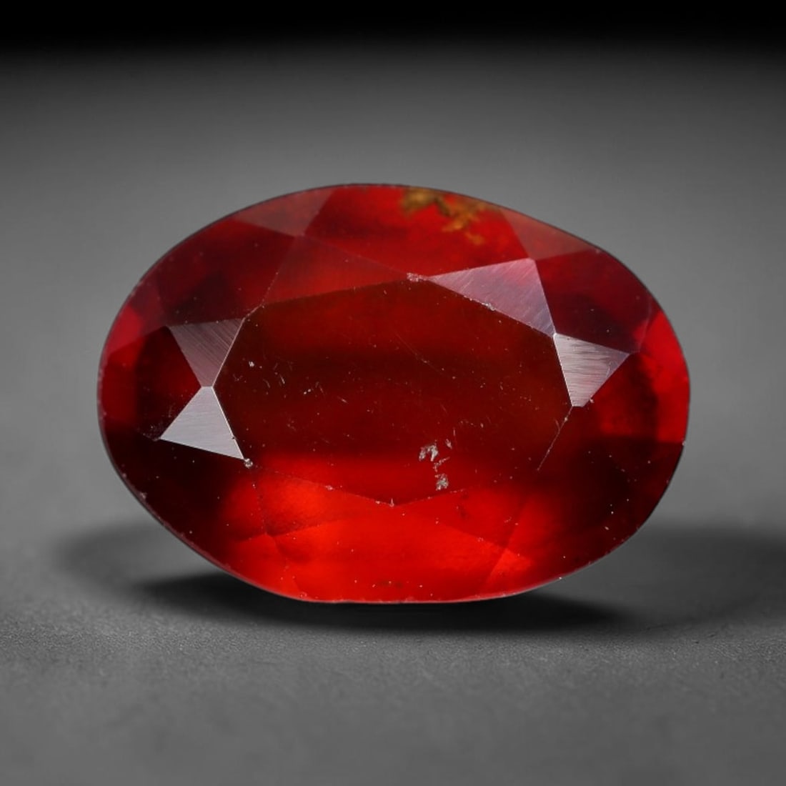 3.36 Carats Natural Hessonite Garnet Oval Faceted Gemstone, 6XZ: I've got a lovely lot here to show you, this bright single faceted hessonite garnet bursting with rich fiery red-orange color. This oval cut stone measures 11.1x8.0x4.5mm and weighs 3.36 carats total.