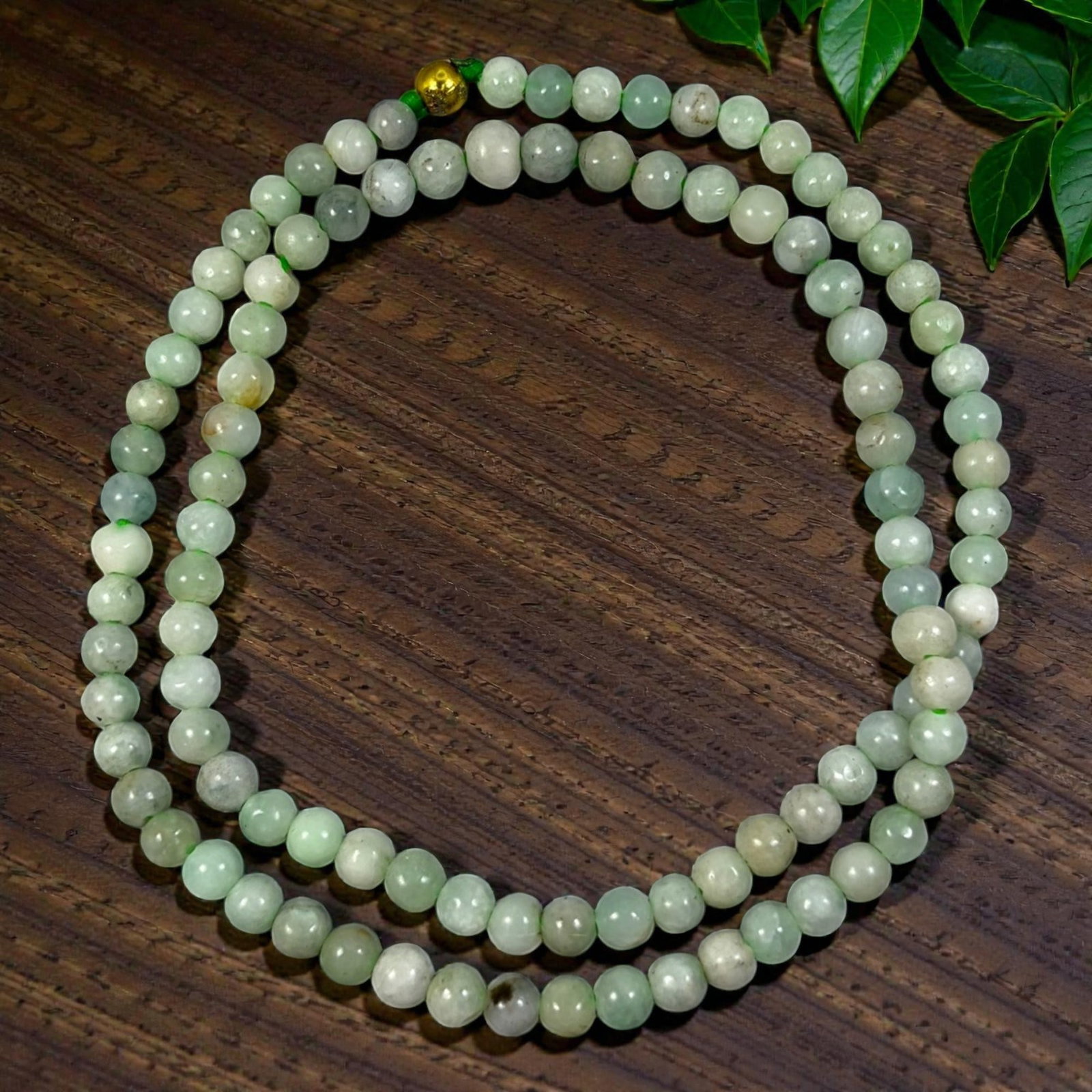 Natural Burmese Pale Green Type A Jadeite Jade Bead Necklace, 30YG: A continuous strand of uniformly spherical polished Type A jadeite beads displaying blended soft pale green and milky white natural tones, marked by subtle internal mineral inclusions and mild individ