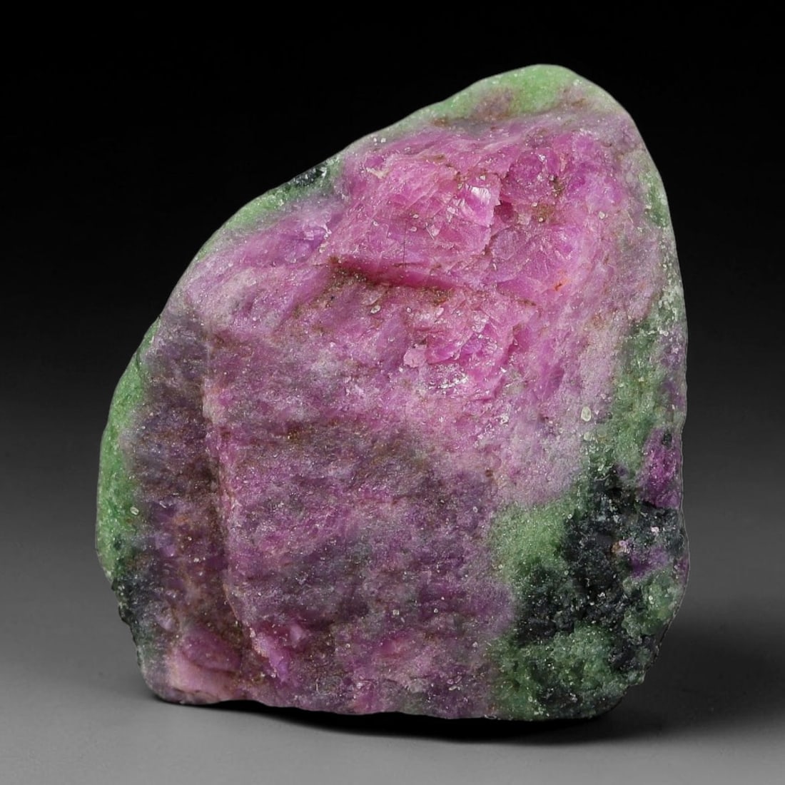 115ct Natural Tanzanian Ruby Zoisite Raw Rough Specimen Mineral Stone, 99YK: This unpolished mineral rough is natural ruby zoisite sourced from Tanzania, exhibiting distinct banded mineral segregation of vibrant green zoisite, magenta ruby crystals, and dark hornblende inclusi
