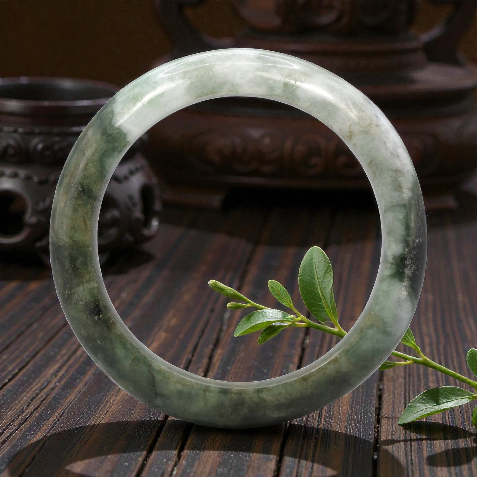 Natural Burmese Type A Jadeite Jade Bangle Bracelet, 20th Century, 2ZL: Carved from jadeite jade with a variegated palette of pale green and deep blackish-green mottling throughout, the bangle is formed as a continuous circular band with a rounded cross-section. The surfa