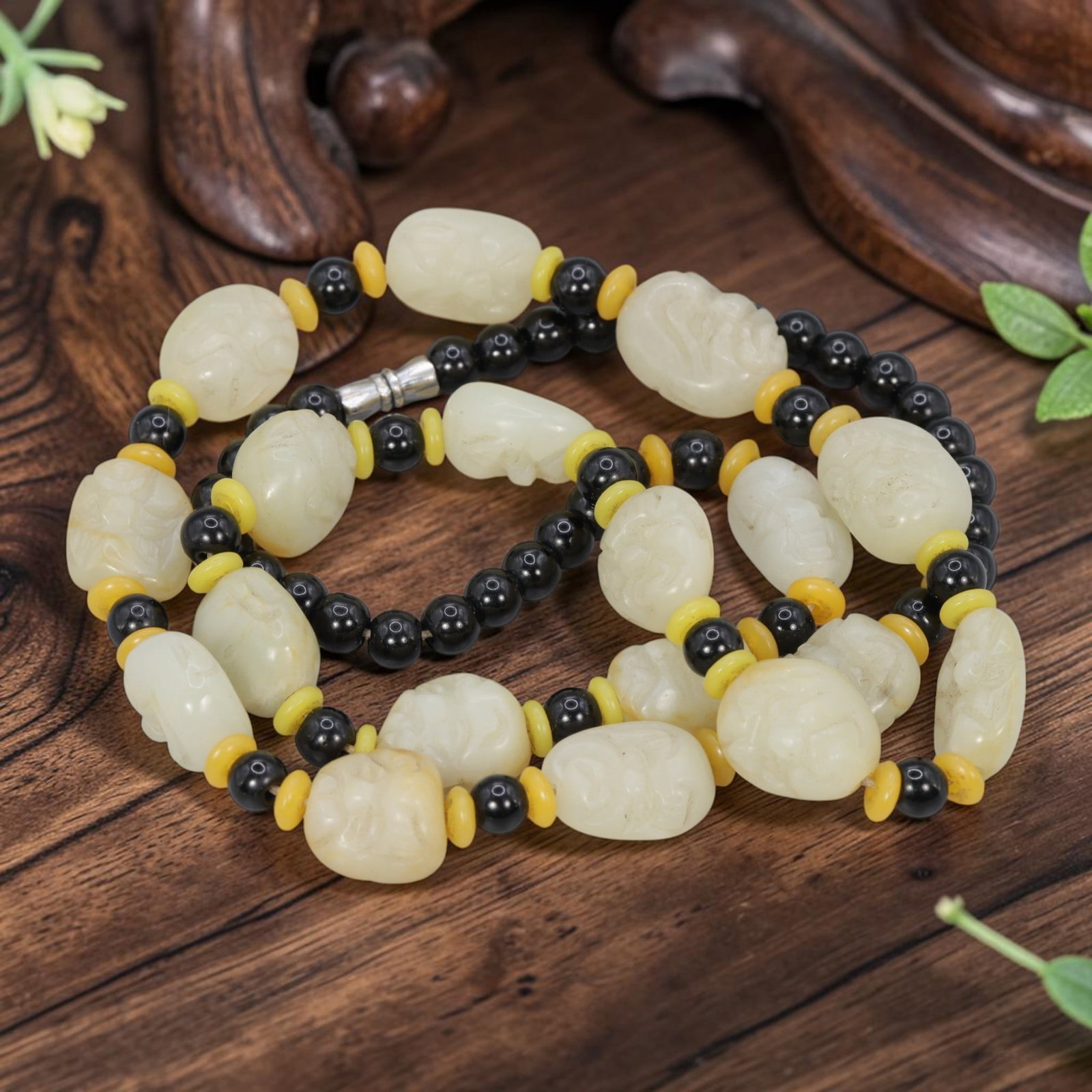 Natural Xinjiang Hetian Jade Necklace - 18 Luohan Heads Carved Beads, 100YJ: This necklace features a full set of 18 carved luohan heads made from natural Xinjiang Hetian jade, paired with black round beads and yellow spacer beads. Each luohan head is individually carved from 