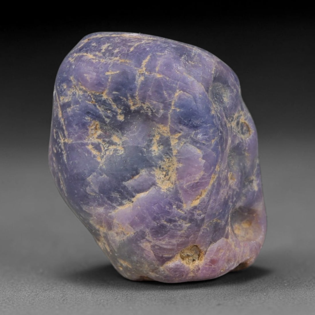 56ct Natural Unheated Sri Lankan Purplish Blue Sapphire Rough, 25YQ: This natural corundum rough is an unheated purplish blue sapphire sourced from Sri Lankan alluvial gem deposits, featuring an irregular natural native form with residual pale yellow-brown mineral matr