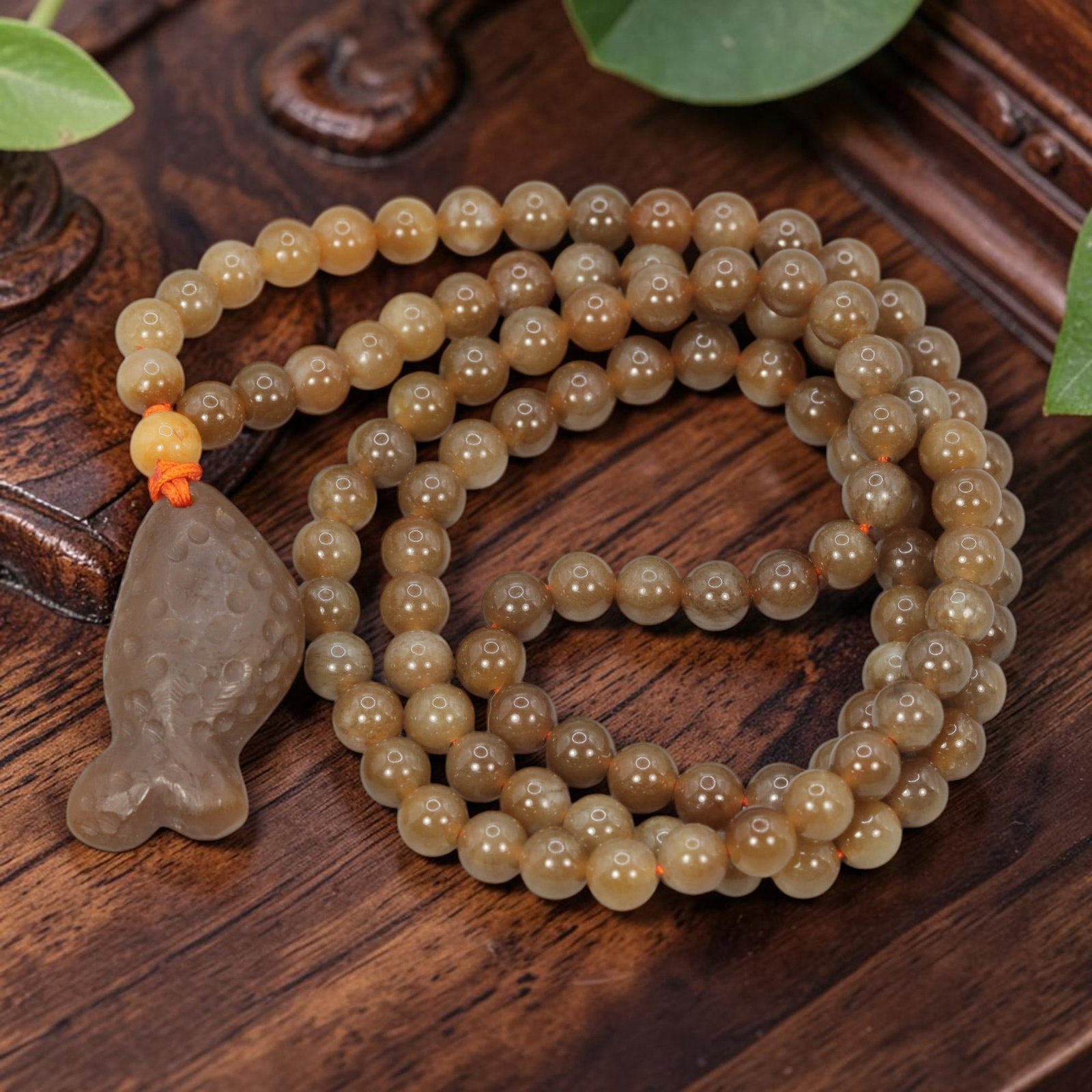 Natural Hetian Sugar Jade Necklace - Carved Fish Pendant, 99YJ: This necklace features a carved fish pendant made from natural Hetian sugar jade, paired with matching round Hetian sugar jade beads. The pendant is crafted from warm caramel-toned sugar jade, depicti