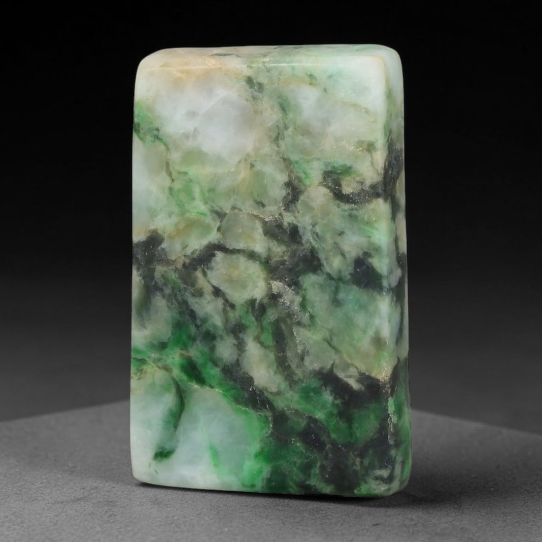 220ct Natural Type A Burmese Jadeite Jade Sliced Rough, 54YK: This specimen is a sliced rough block of natural Type A Burmese jadeite jade. The interior displays natural colour zoning with visible mineral veining and crystalline patterns typical of unprocessed j