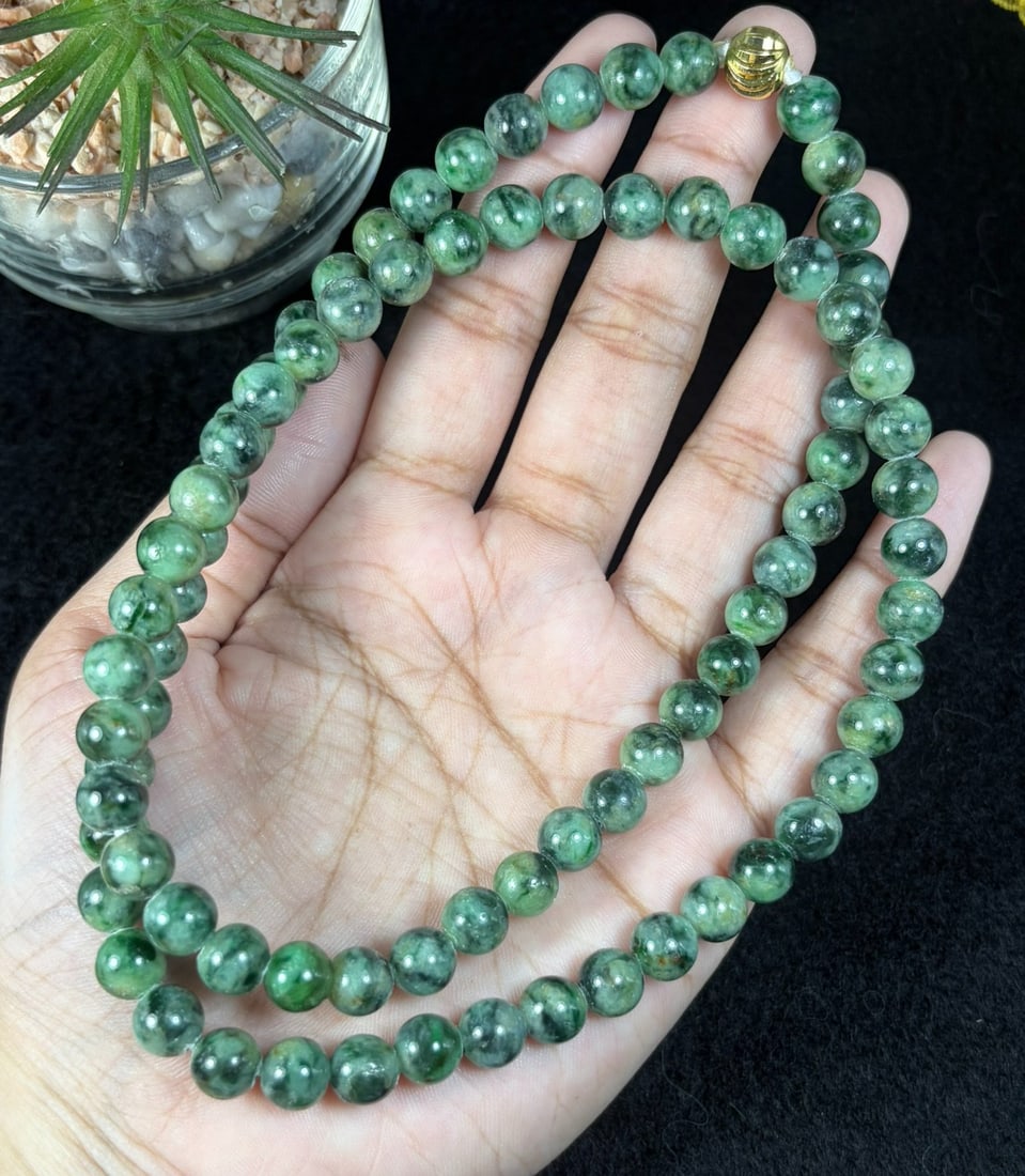 Natural Burmese Type A Dark Floating Green Jadeite Beaded Necklace, 24YM: Hand-strung natural Burmese Type A jadeite round beads with rich deep green mossy floating inclusions throughout each polished bead. Every sphere features natural marbled green veining against a pale 
