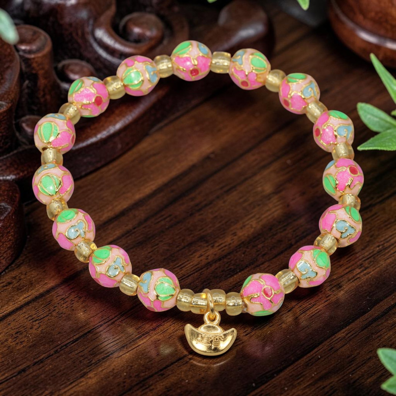 A Chinese Cloisonne Enamel Beaded Bracelet - Pink Gold-Tone Ingot Charm, 50YJ: This modern Chinese-style bracelet features 7.80mm round cloisonne enamel beads in a soft pink hue, each detailed with raised gold-tone outlines framing colorful floral and cloud motifs accented with 