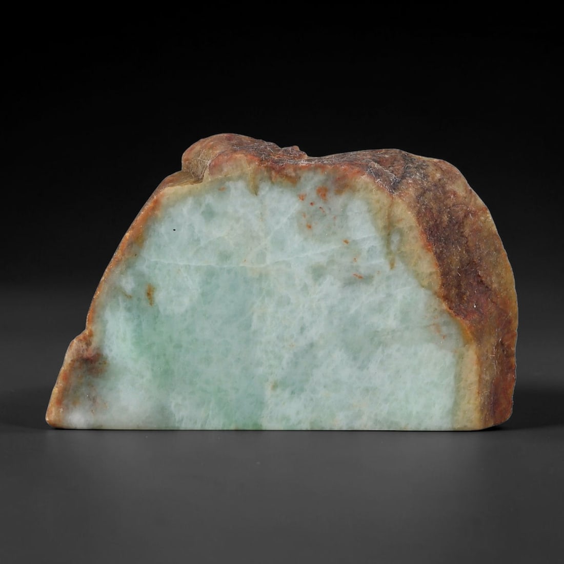 305ct Natural Type A Burmese Jadeite Jade Sliced Rough, 66YK: This specimen is a sliced rough block of natural Type A Burmese jadeite jade. The interior displays natural colour zoning with visible mineral veining and crystalline patterns typical of unprocessed j