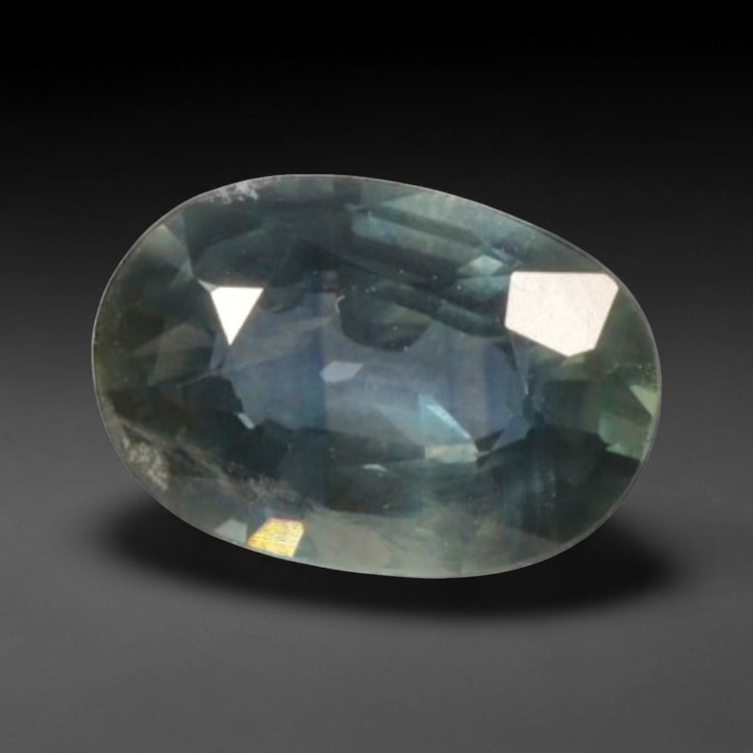 0.80 Carats Natural Montana Teal Sapphire Oval Faceted Gem, 76YE: Let me share with you this really nice little faceted sapphire, mined straight out of Montana with such unique shifting cool tones you don't see every day! This stone has a moody blended teal-blue bas