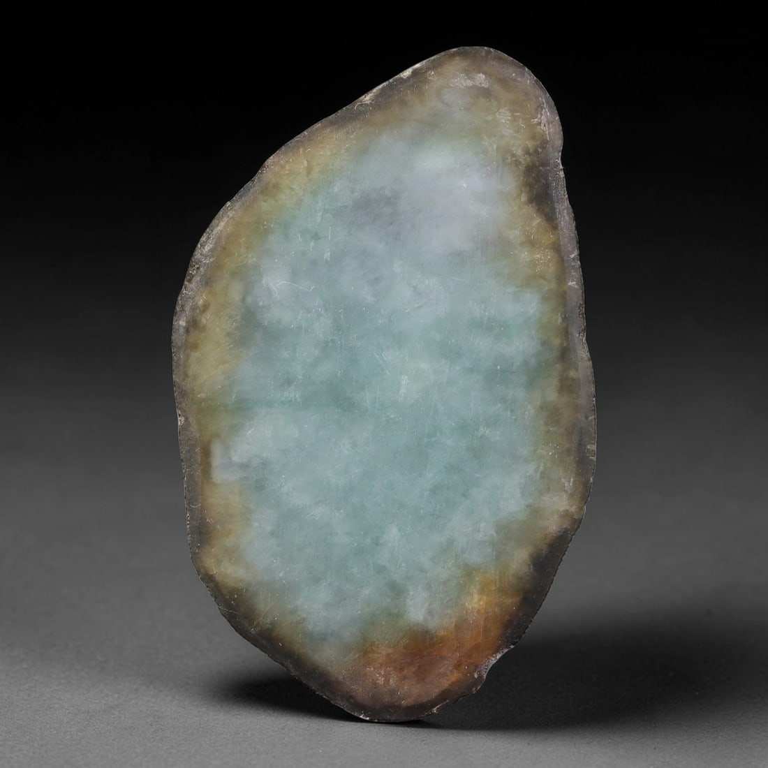 285ct Natural Type A Burmese Jadeite Jade Sliced Rough, 36YK: This specimen is a sliced rough block of natural Type A Burmese jadeite jade. The interior displays natural colour zoning with visible mineral veining and crystalline patterns typical of unprocessed j