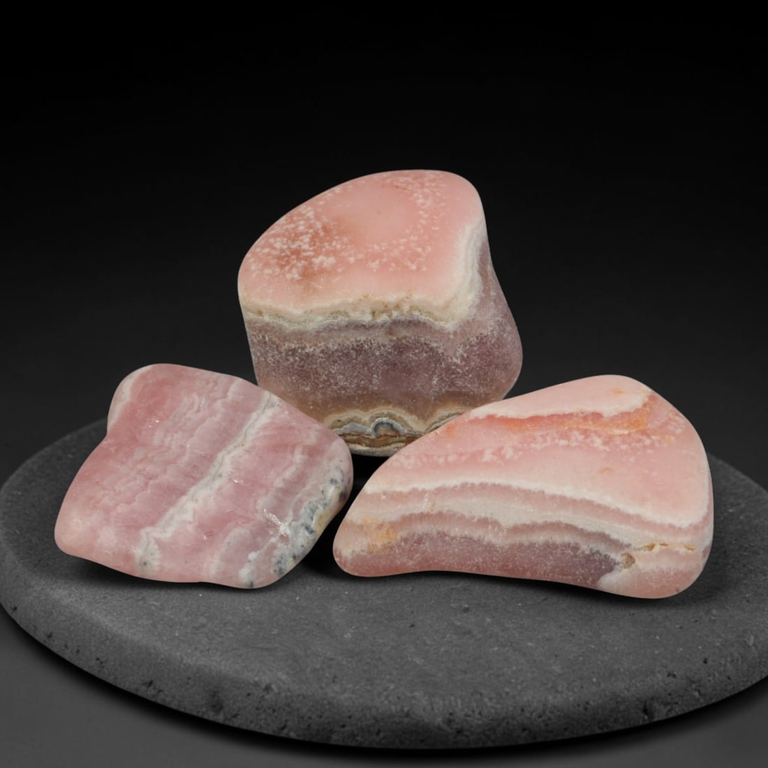 40ct 3pcs Natural Argentine Rhodochrosite Banded Tumbled Rough Set, 3YR: This listing features three individual tumbled rhodochrosite rough pieces sourced from Argentina Capillitas deposits, each showcasing distinct layered banding of soft rose pink, cream white and pale t