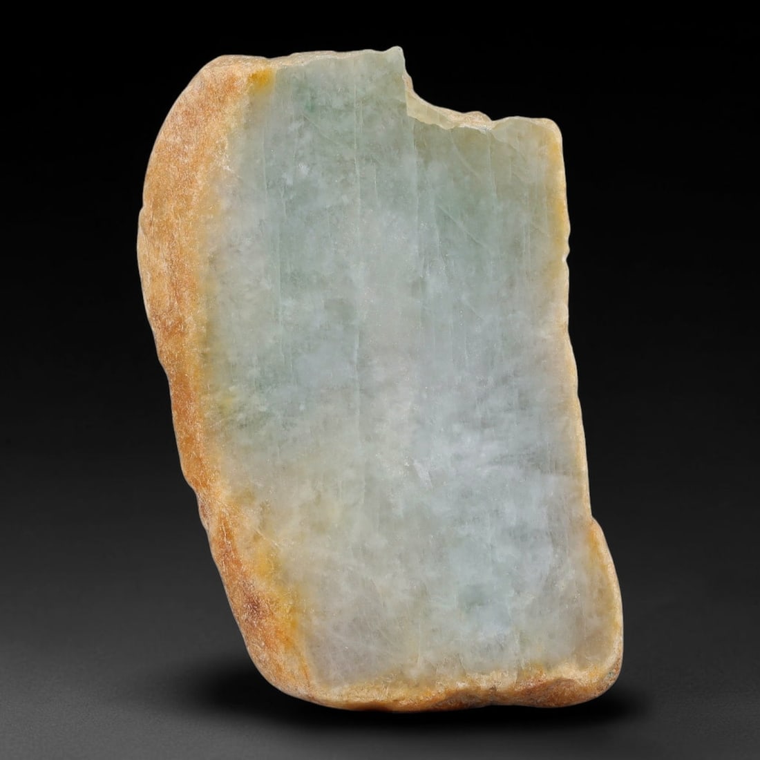 258ct Natural Type A Burmese Pale Ice Green Jadeite Jade Sliced Rough, 52YN: This specimen is a natural sliced rough slab of untreated Type A Burmese jadeite, retaining continuous weathered tan outer rind around its perimeter, with a polished cut interior showcasing semi-trans