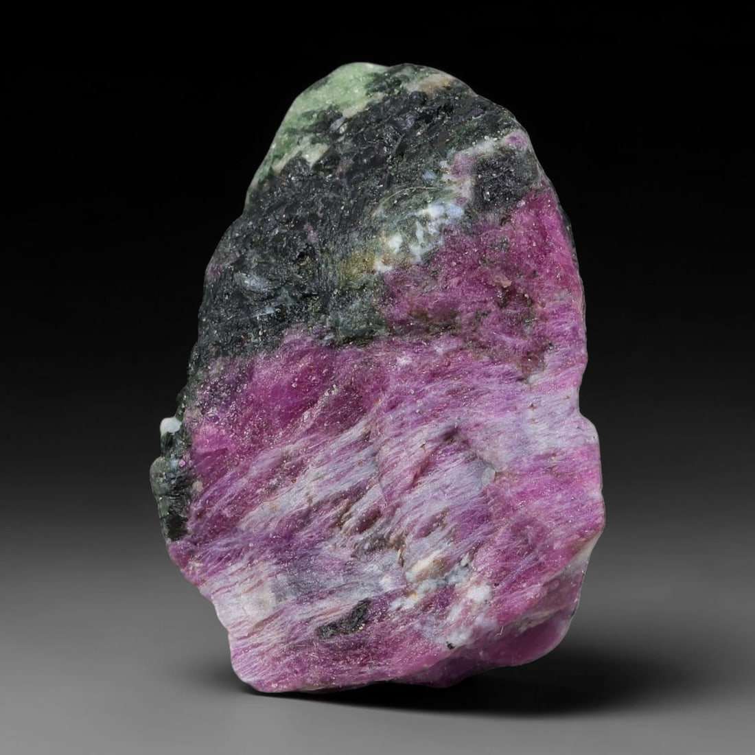 110ct Natural Tanzanian Ruby Zoisite Raw Rough Specimen Mineral Stone, 92YK: This unpolished mineral rough is natural ruby zoisite sourced from Tanzania, exhibiting distinct banded mineral segregation of vibrant green zoisite, magenta ruby crystals, and dark hornblende inclusi