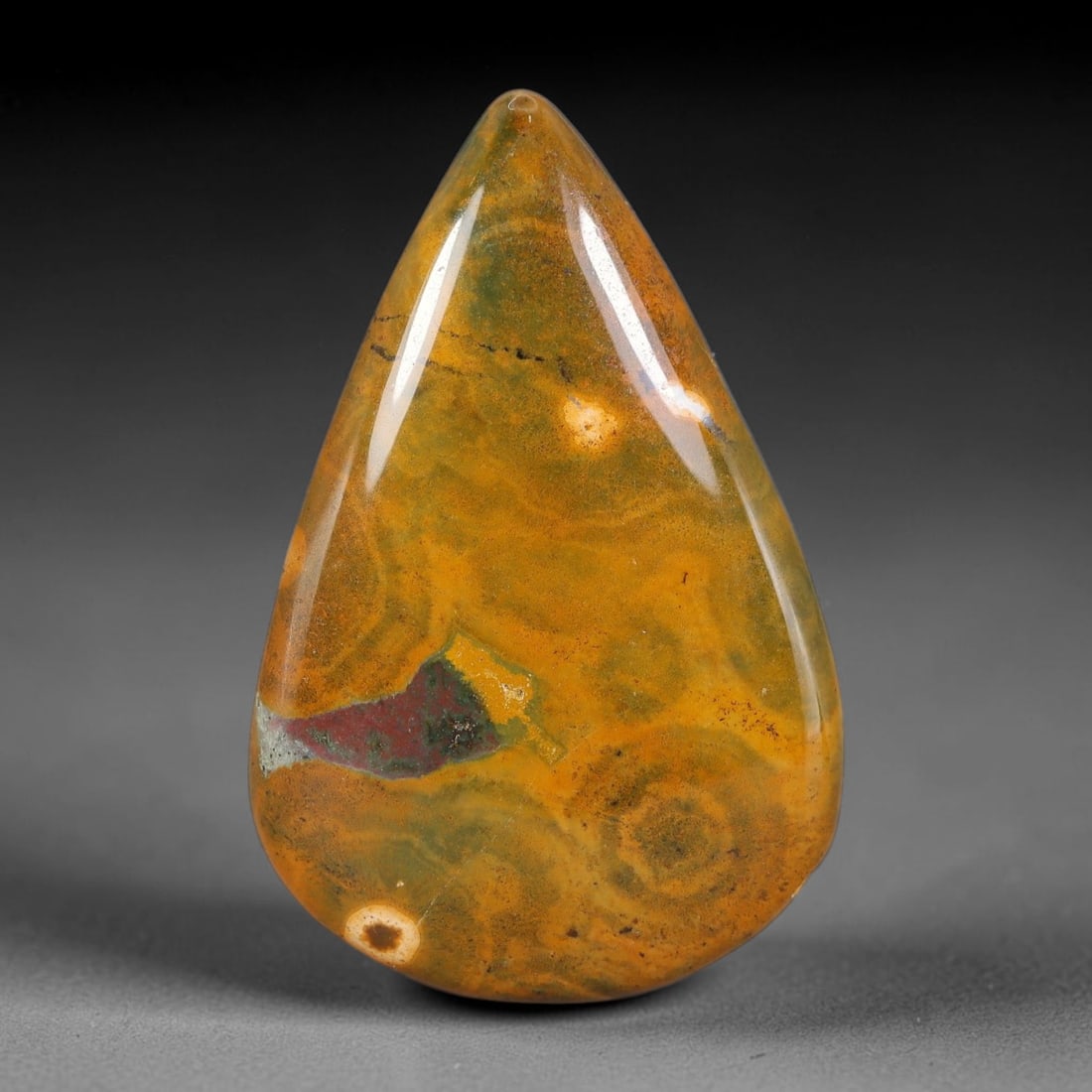 40.10 Carats Natural Orbicular Ocean Jasper Teardrop Cabochon Gemstone, 23XZ: This elegantly shaped pear/teardrop cabochon measures 39.4x25.8x5.2mm and weighs a total of 40.10 carats. It features a rich golden ochre and olive-green base laced with delicate swirling banding, dis
