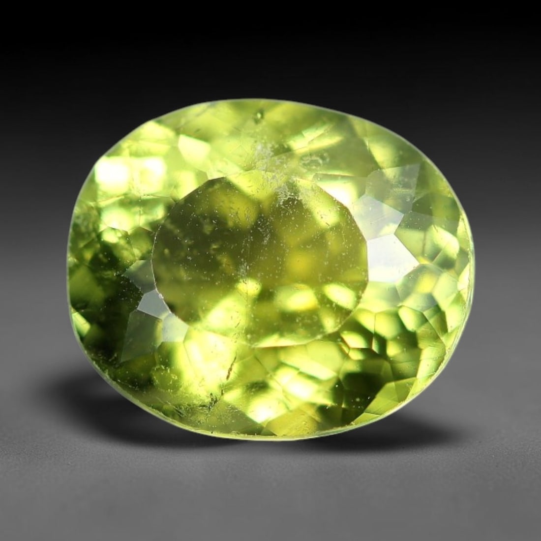 1.30 Carats Natural Green Tourmaline Oval Faceted Loose Gemstone, 71XZ: This specimen consists of natural tourmaline, finished with consistent faceting to facilitate light refraction through its crystalline body. The mineral holds rich green colour saturation with subtle 