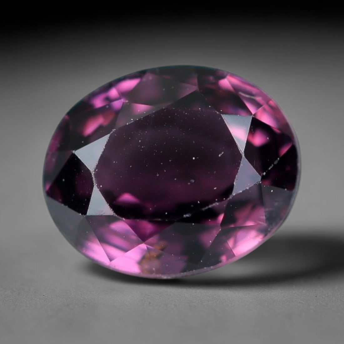 1.09 Carats Natural Pink Spinel Oval Faceted Loose Gemstone, 16XZ: This specimen is formed of natural spinel, worked with precise faceting across its crystalline body to optimise light interaction within the stone's internal structure. The mineral holds consistent pi