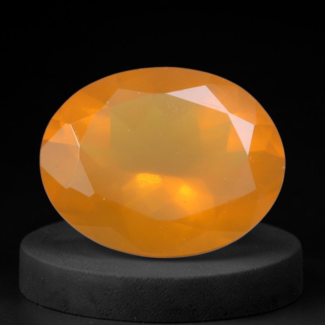 1.87 Carats Mexican Fire Opal Oval Cut - Natural Loose Gemstone, 89XY: This luminous Mexican fire opal radiates with a warm, vibrant orange hue, reminiscent of glowing embers or golden sunset light. Its faceted oval cut creates a soft, ethereal play of light, with subtle