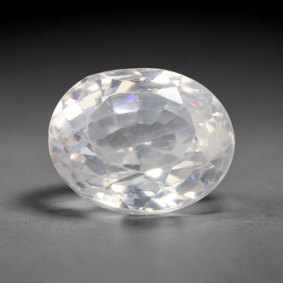 2.65 Carats Colorless White Zircon Oval - Natural Cambodian Stone, 81XC: This brilliant oval-cut white zircon dazzles with exceptional sparkle, its high refractive index creating vivid flashes of light that rival more costly gemstones. The stone's colorless body allows its
