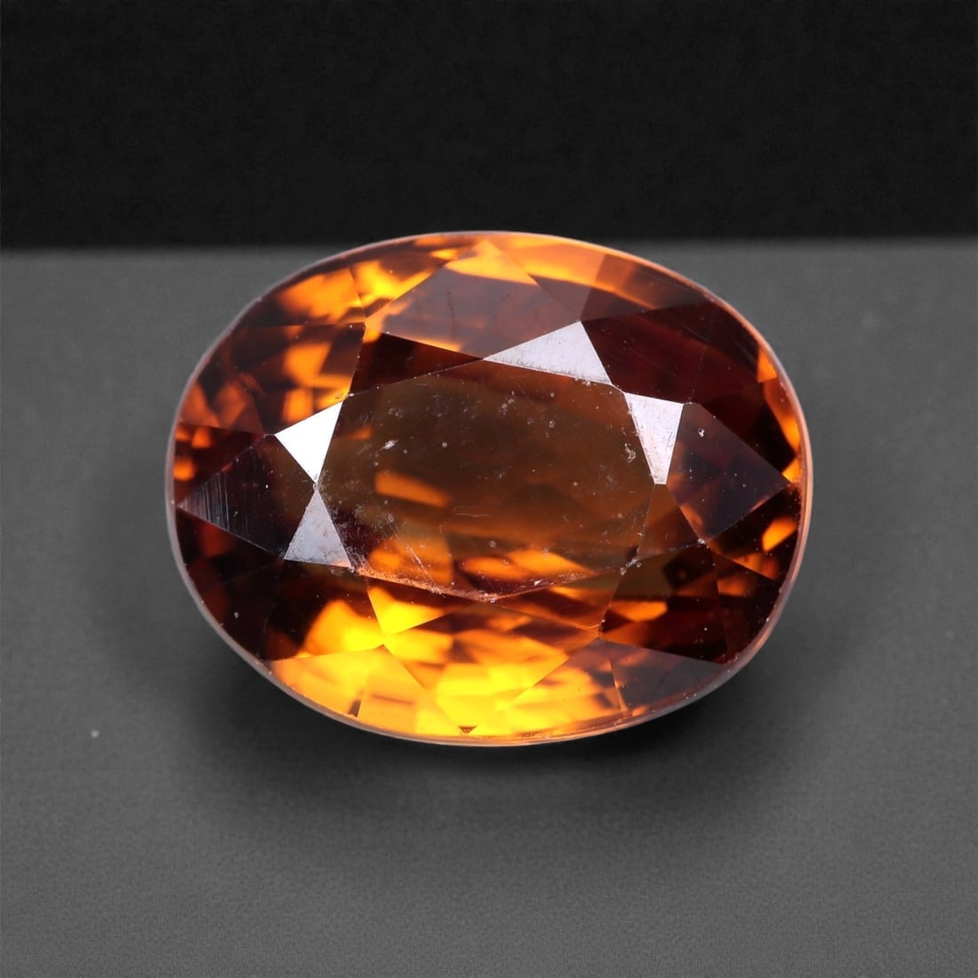 3.81 Carats Golden Cinnamon Zircon - Natural Cambodian Gem 9x7mm, 1XC: This richly colored zircon glows with a fiery golden cinnamon tone, flashing vibrant amber and burnt orange hues as light moves across its surface. The gem's exceptional brilliance and high refractive
