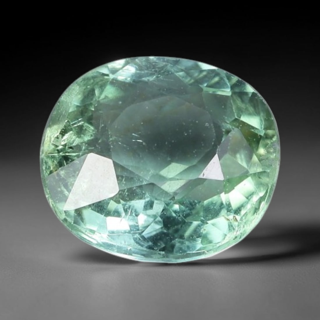 1.36 Carats Seafoam Green Tourmaline Oval Cut - Natural Loose Gemstone, 50XC: This luminous oval-cut tourmaline features a soft, ethereal seafoam green hue, evoking the tranquil glow of sunlit coastal waters. Its crisp faceting creates a brilliant play of light, with subtle col