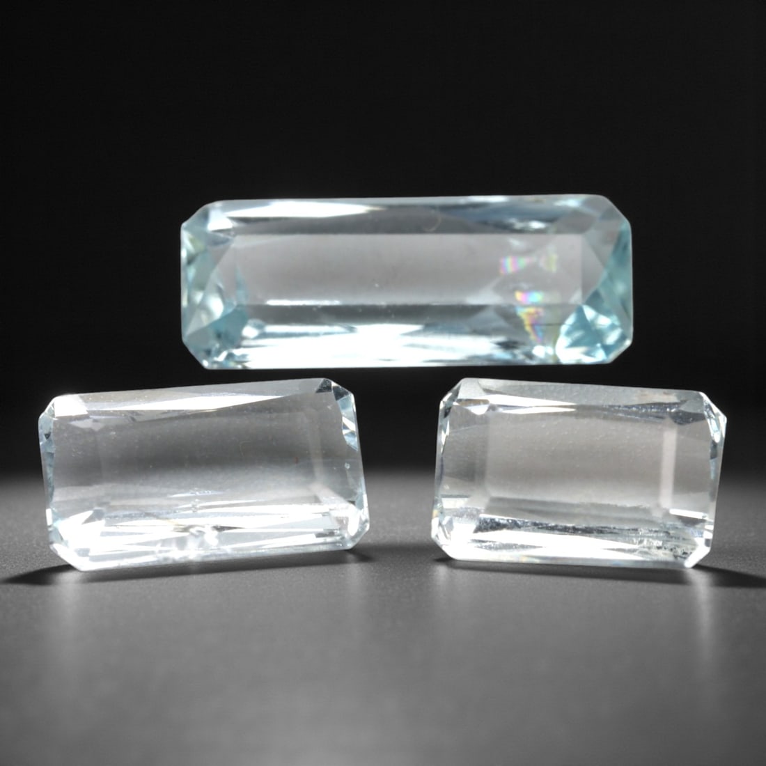 4.03 Carats Light Blue Brazilian Aquamarine Baguette Parcel , 63XK: This refined parcel of aquamarine gemstones presents a clean, icy light blue color with crisp transparency and a cool, watery glow. Cut into elongated baguette shapes, the stones display sleek linear 