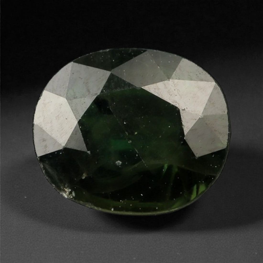 1.77 Carats Deep Green Sapphire - Natural Sri Lankan Stone , 53WE: This compelling deep green sapphire showcases an earthy richness that draws the eye into its dark, velvety core. Hints of mossy and forest tones emerge under direct light, adding dimension to its othe