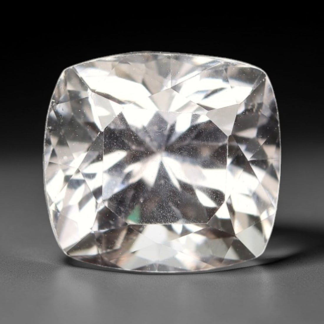6.18 Carats Colorless Kunzite - Natural Afghan Gemstone, 22XP: This luminous cushion-cut kunzite measures 10.5 x 9.7 x 8.5 mm, radiating with a pure, colorless clarity that evokes the brilliance of polished ice and starlight. The precision cushion faceting maximi