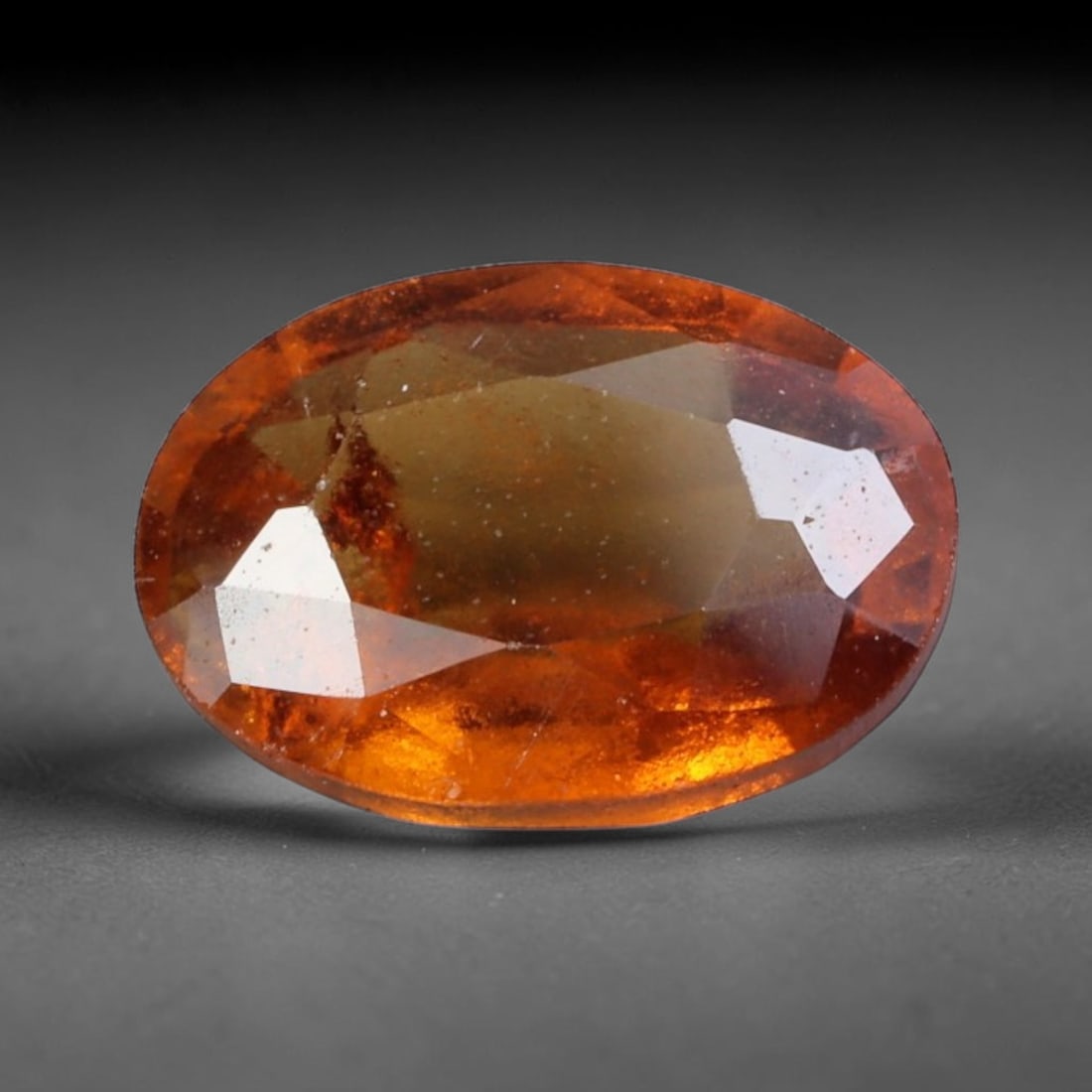 2.01 Carats Rich Cinnamon Hessonite Garnet Oval - Natural Sri Lankan Stone, 81XY: This singular oval-cut hessonite garnet, measuring 9.0 x 6.4 x 3.9 mm, glows with a rich, warm cinnamon-orange hue reminiscent of sunlit amber and aged honey. Its faceting captures light to reveal fie