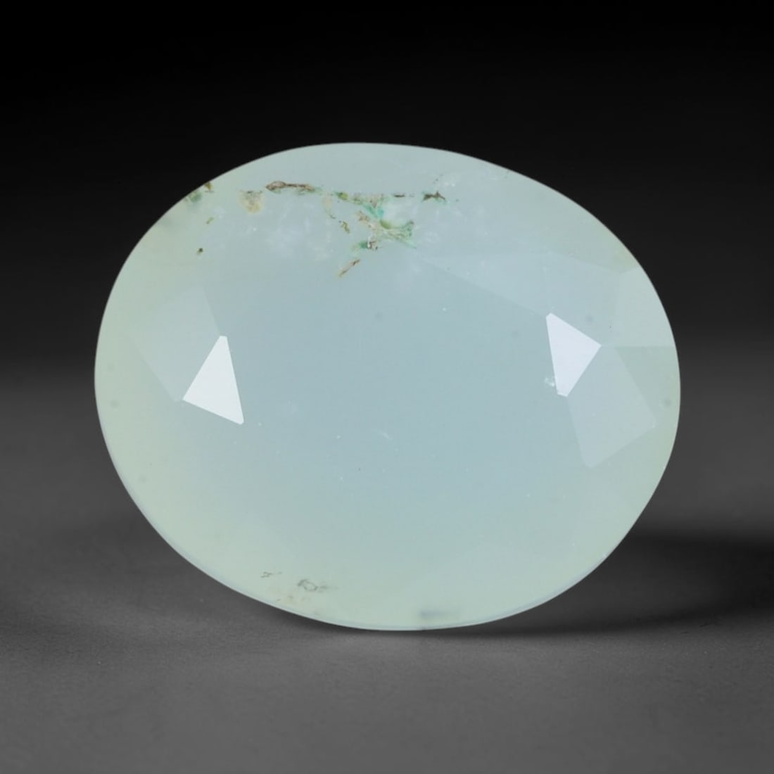 2.83 Carats Soft Blue Peruvian Paraiba Opal Oval - Natural Stone, 85XY: This singular oval-cut Peruvian opal, measuring 10.9 x 9.2 x 6.4 mm, radiates with a soft, milky blue hue reminiscent of misty lagoons and pale tropical skies. Its faceting creates a gentle, even glow