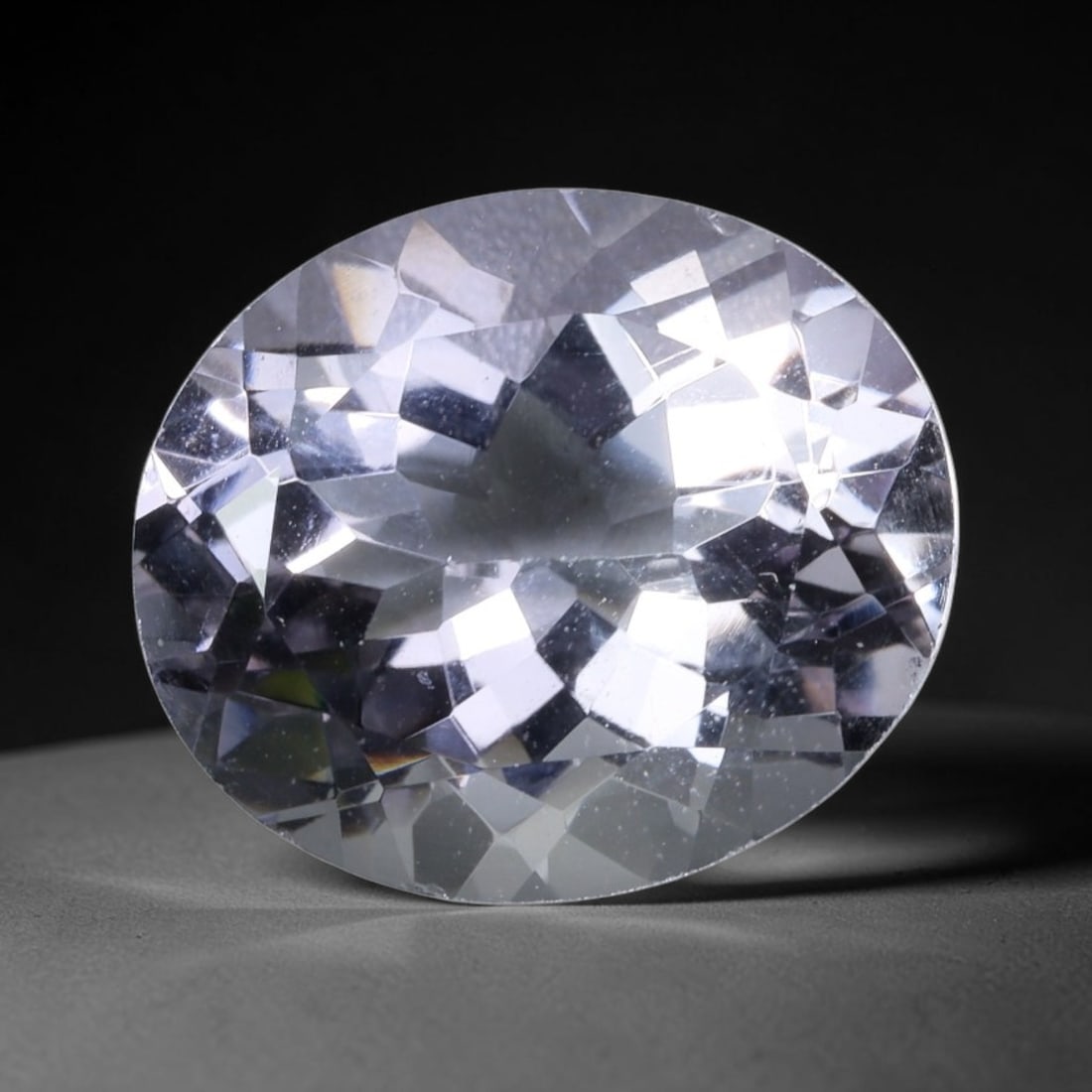 6.75 Carats Clear White Oval Amethyst - Natural Loose Gemstone, 81XB: This striking oval amethyst exhibits a stunning, colorless clarity that allows light to flood through its precisely cut facets, creating brilliant, diamond-like sparkle and fire. Measuring 14.0x12.0x7