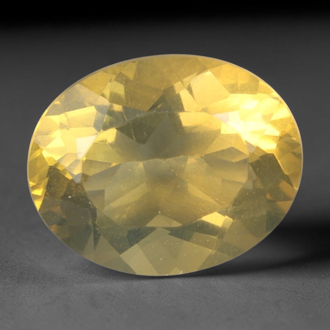 2.46 Carats Golden Yellow Fire Opal Oval - Natural Mexican Stone, 42XC: This luminous oval-cut fire opal radiates a rich golden-yellow hue, evoking the warm glow of desert sunlight. The stone's faceted cut creates a soft, liquid brilliance, highlighting its characteristic