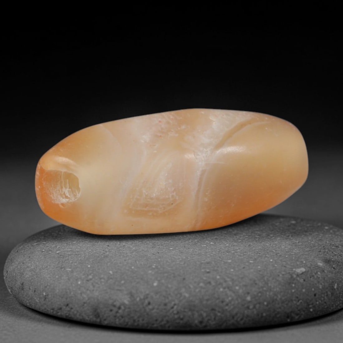 Ancient Indo-Scythian Honey Carnelian Chalcedony Small Barrel Amulet Bead (150 BCE - 400 CE), 31XD: This warm translucent honey-toned carnelian barrel bead originates from Indo-Scythian Central Asian stone craft traditions, artisans renowned for crafting smooth solid-hue chalcedony talismans for nom