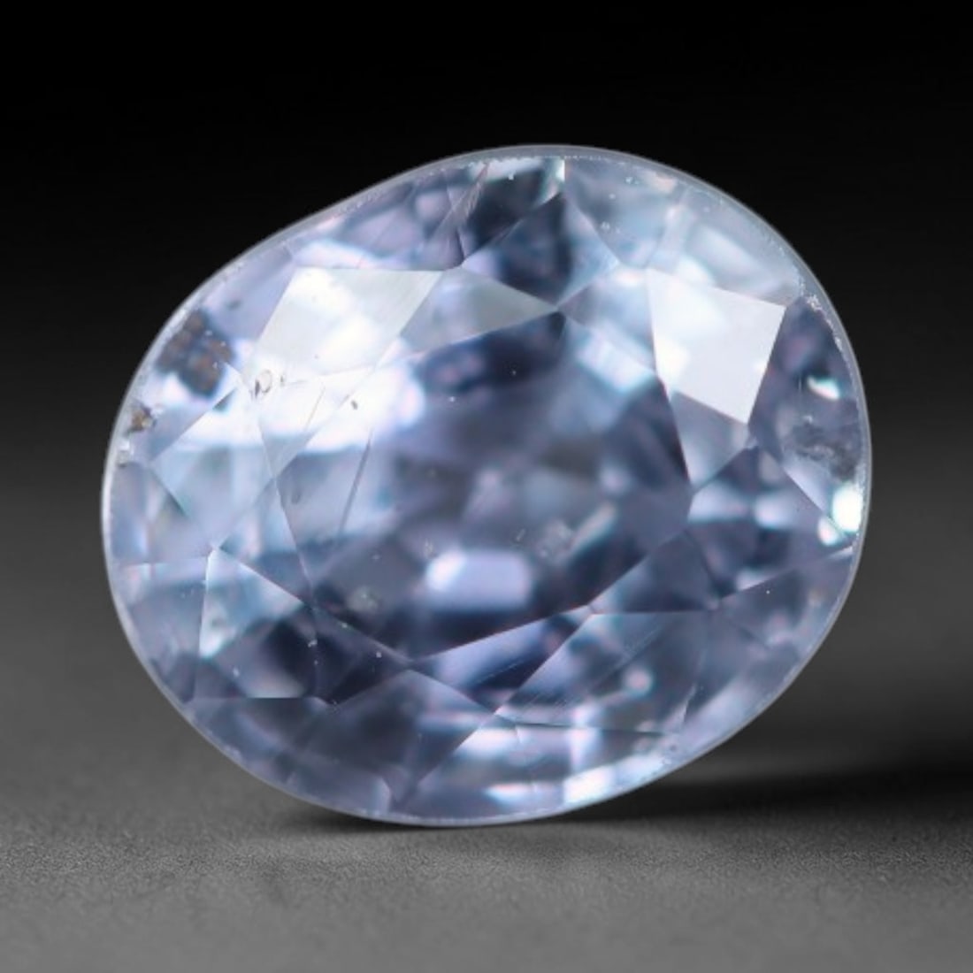 0.63 Carats Natural Light Blue Sapphire Oval Faceted Loose Gemstone, 81XV: Natural pale light blue corundum sapphire precision cut into an oval faceted loose gemstone, finished with mixed brilliant facets to enhance light performance. The crystal bears a soft airy sky-blue t