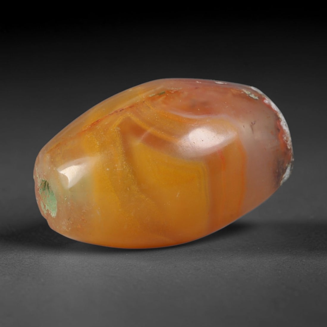 Ancient Achaemenid Persian Carnelian Banded Agate Barrel Bead (550-330 BCE), 4XV: This antique banded carnelian barrel bead originates from the Achaemenid Persian Empire, whose royal hardstone workshops created luminous warm-toned chalcedony talismans for Persian nobility and cross
