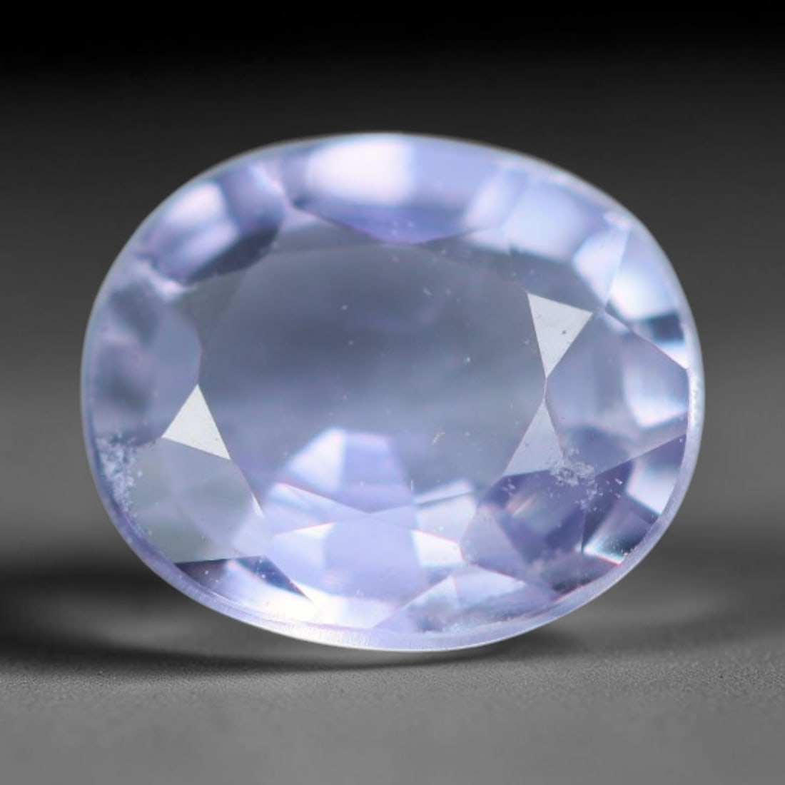 0.62 Carats Natural Lavender Sapphire Oval Faceted Loose Gemstone, 63XV: Natural lavender sapphire cut into an oval faceted loose gemstone, fashioned with mixed brilliant facets to maximise light refraction. The stone displays a soft pale violet-lavender hue with moderate 