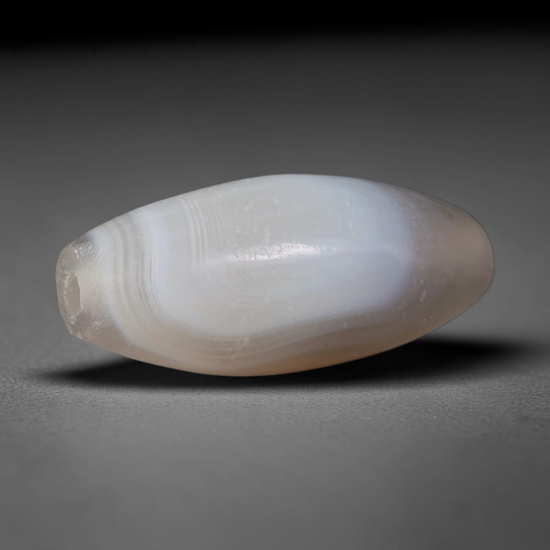 Ancient Greco-Roman Levantine Banded Agate Bicone Bead (332 BCE - 400 CE), 8XV: This antique banded agate bicone bead originates from Greco-Roman Levantine workshops, coastal Mediterranean artisans that mass-produced minimalist layered chalcedony beads for daily noble adornment a