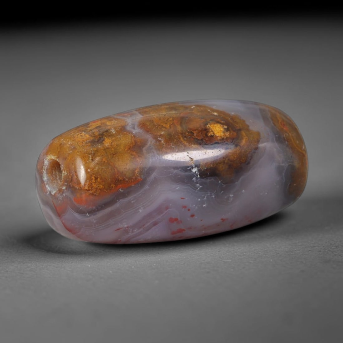 Ancient Assyrian Civilization Banded Agate Barrel Bead (2500-609 BCE), 89XD: This antique banded agate barrel bead originates from the Assyrian Civilization, a prominent West Asian culture that carved ornate agate beads for palace regalia and elite funerary adornment traded ac