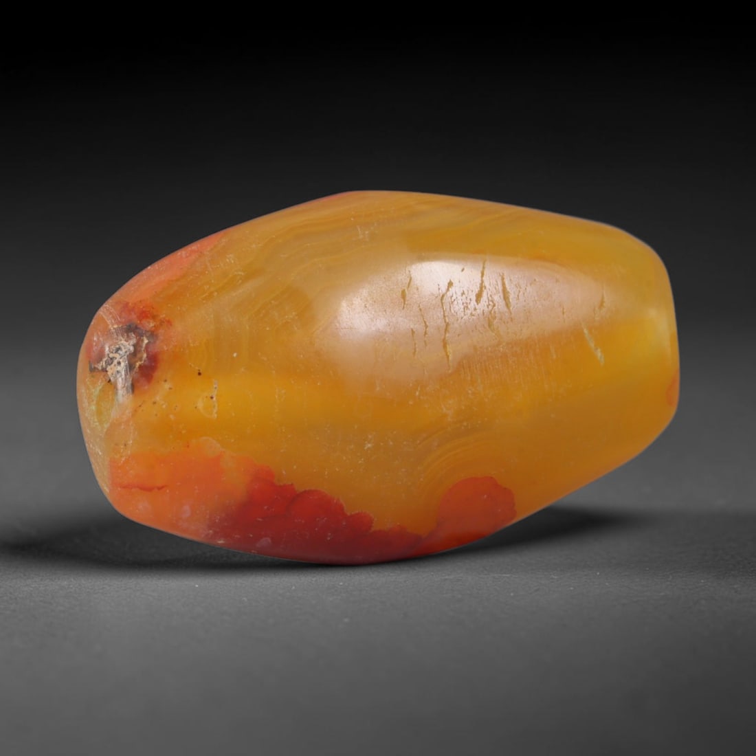 Ancient Phoenician Culture Banded Agate Bicone Bead (3000-300 BCE), 99XD: This antique banded agate bicone bead originates from Phoenician Culture, maritime Levantine artisans who crafted vibrant carnelian-agate trade beads to circulate across the entire Mediterranean basin
