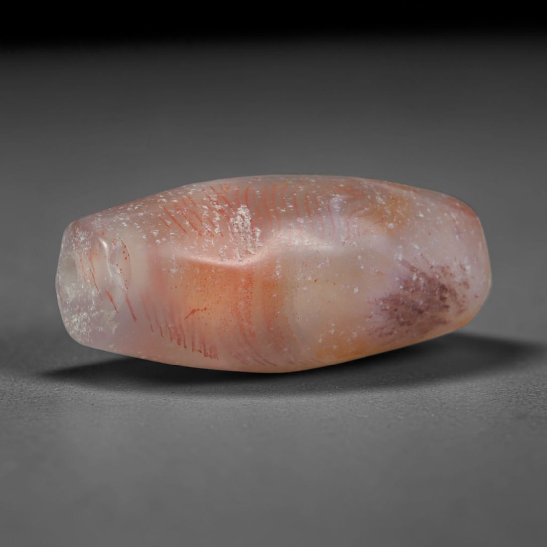 Ancient Gandhara Fine Red Vein Chalcedony Slender Barrel Trade Bead (600 BCE - 500 CE), 44XD: This antique fine red striated chalcedony barrel bead originates from Gandhara cross-cultural craft hubs, artisans who crafted delicate pale hardstone talismans for Buddhist pilgrims and intercontinen