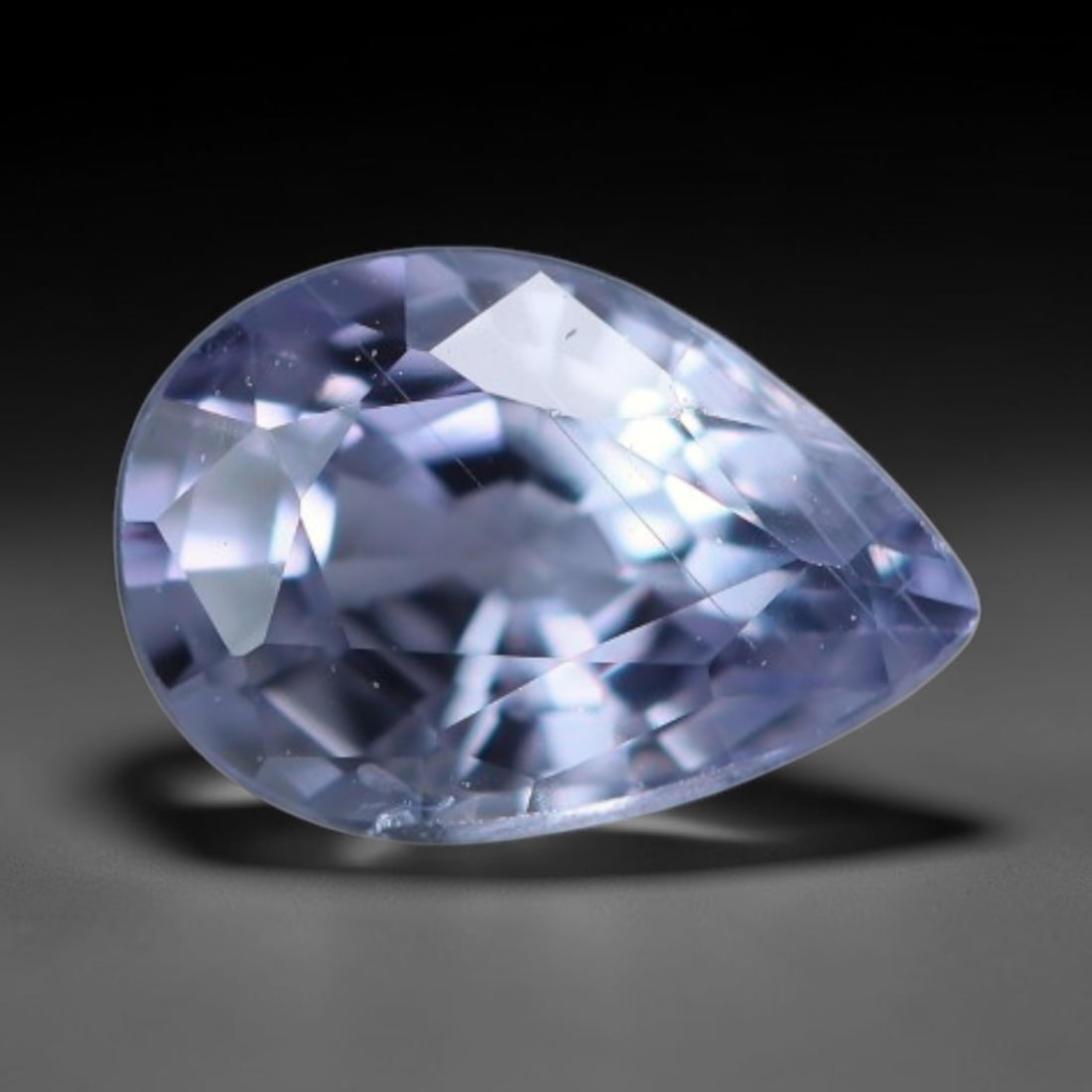 0.54 Carats Natural Blue Sapphire Pear Faceted Loose Gemstone, 77XV: Natural pale blue corundum sapphire precision cut into a pear faceted loose gemstone, finished with mixed brilliant facets to maximize light performance. The crystal bears a soft light blue-lavender u