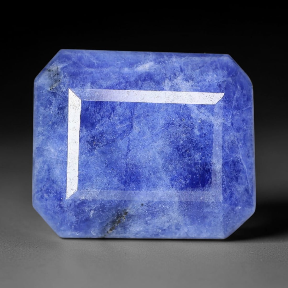 12.08 Carats Natural Royal Blue Emerald Cut Sodalite Loose Faceted Gemstone, 85XV: Natural deep royal blue sodalite precisely cut into a classic emerald step-cut loose gemstone, structured with clean linear step facets to highlight its rich saturated blue matrix and natural mineral 