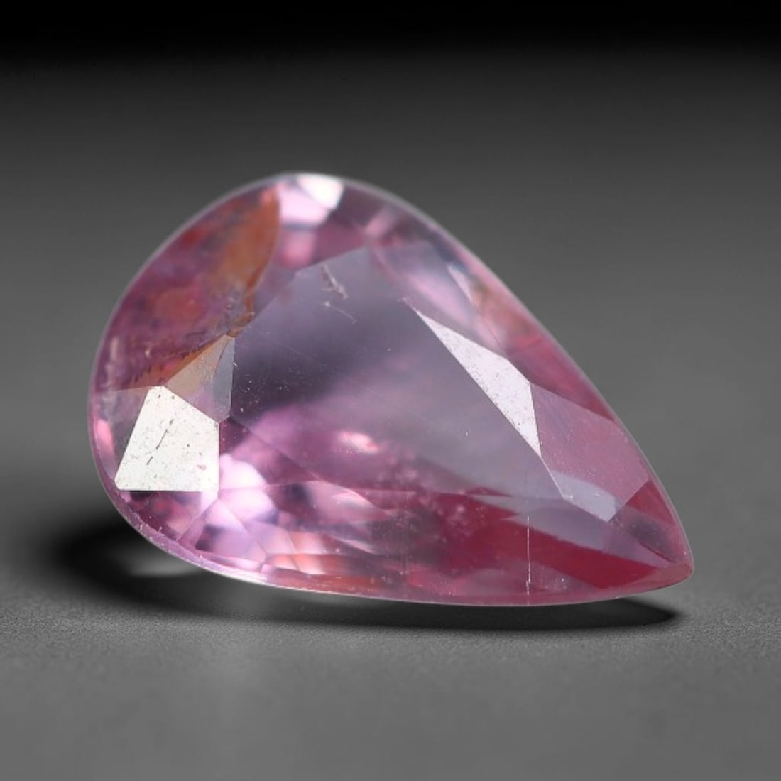 0.40 Carats Natural Bi-Color Pink Peach Pear Sapphire Loose Faceted Gemstone, 69XV: Natural gradient pink-peach corundum sapphire precision cut into a pear-shaped faceted loose gemstone, crafted with mixed brilliant facets to showcase soft shifting pink tonal layers. The crystal feat