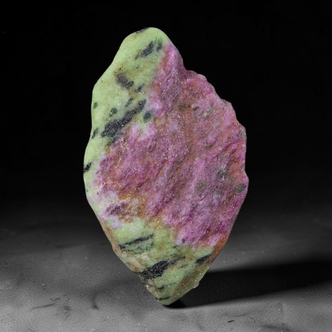 95ct Natural Tanzanian Ruby Zoisite Raw Rough Specimen Mineral Stone, 13YQ: This unpolished mineral rough is natural ruby zoisite sourced from Tanzania, exhibiting distinct banded mineral segregation of vibrant green zoisite, magenta ruby crystals, and dark hornblende inclusi